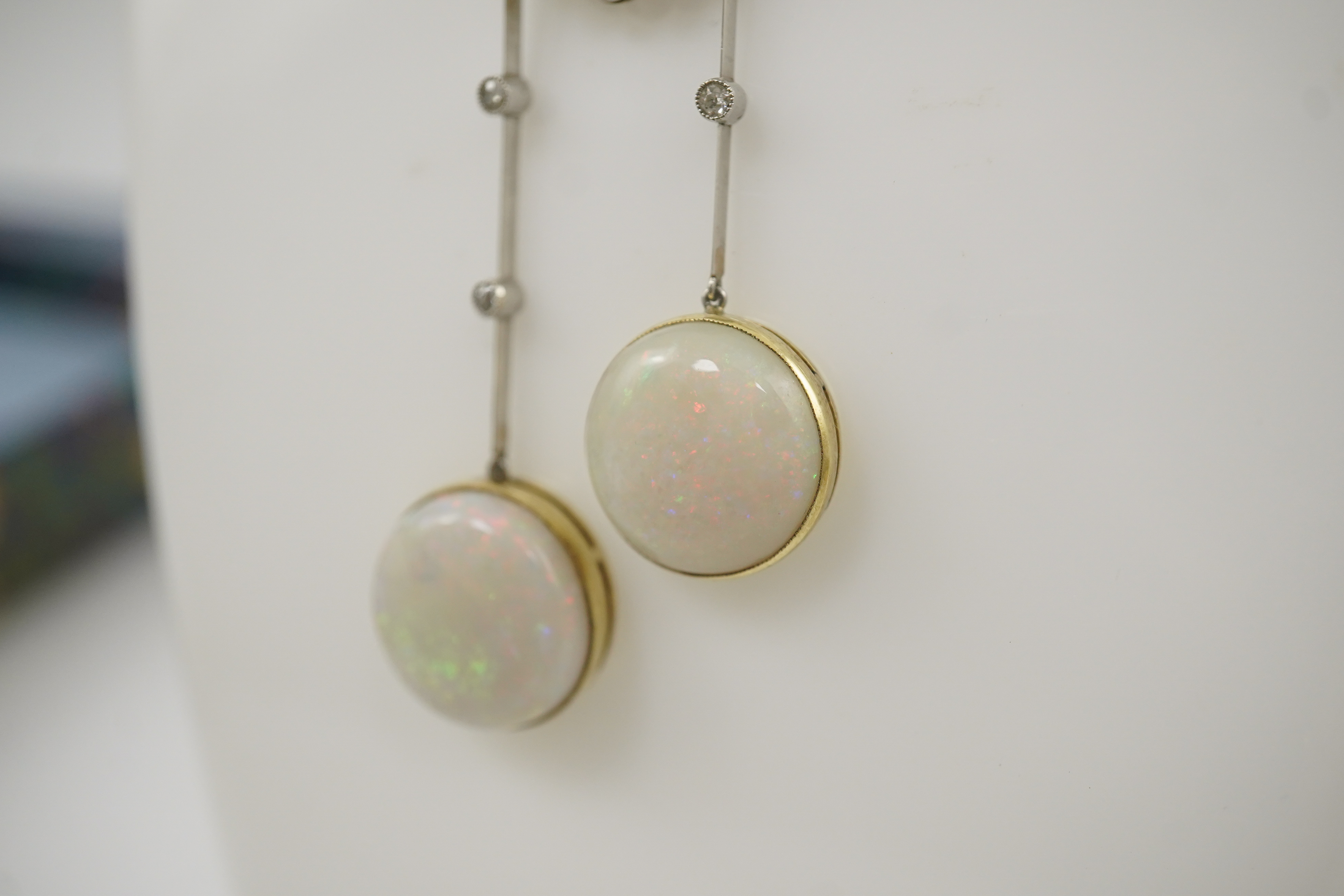 A Belle Epoque platinum and gold, white opal and millegrain set diamond double drop pendant necklace, the chain by Child and Child